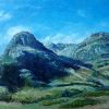 Dark mountains rising steeply either side of a valley under a bright blue sky.