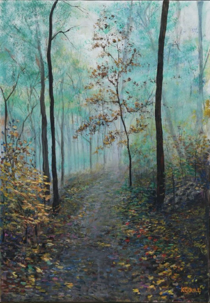 A misty autumn woodland, a leaf-strewn path between bare trees.