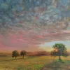 Radiant: a mottled sunset sky over a green field, with the sun behind the right-hand of three trees.