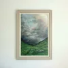 A steep green glen beneath a dark, stormy sky.