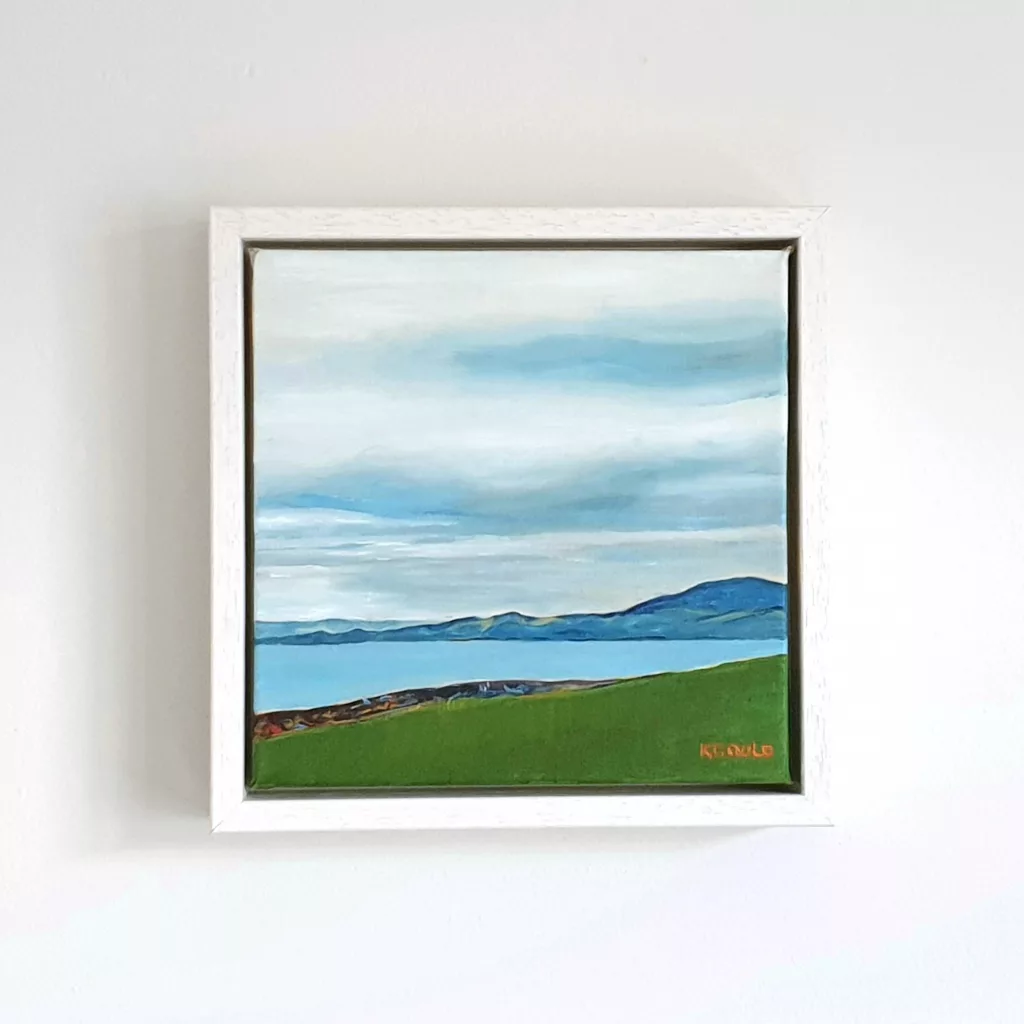 A calm blue sea seen across a green clifftop field.