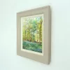 Bluebell Woods in its hand-painted frame, seen from the side on a white wall.