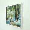 Thaw in its white float frame, seen from the side on a white wall.