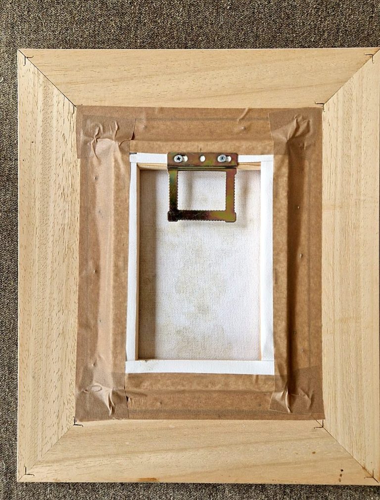Back of a finished frame, the canvas taped in and a picture hanger fitted