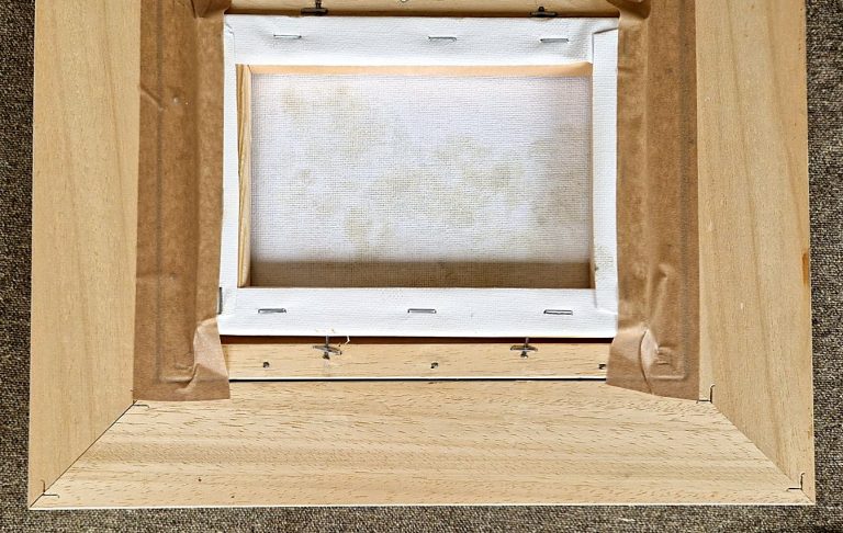 Back of a frame with a stretched canvas fitted into it